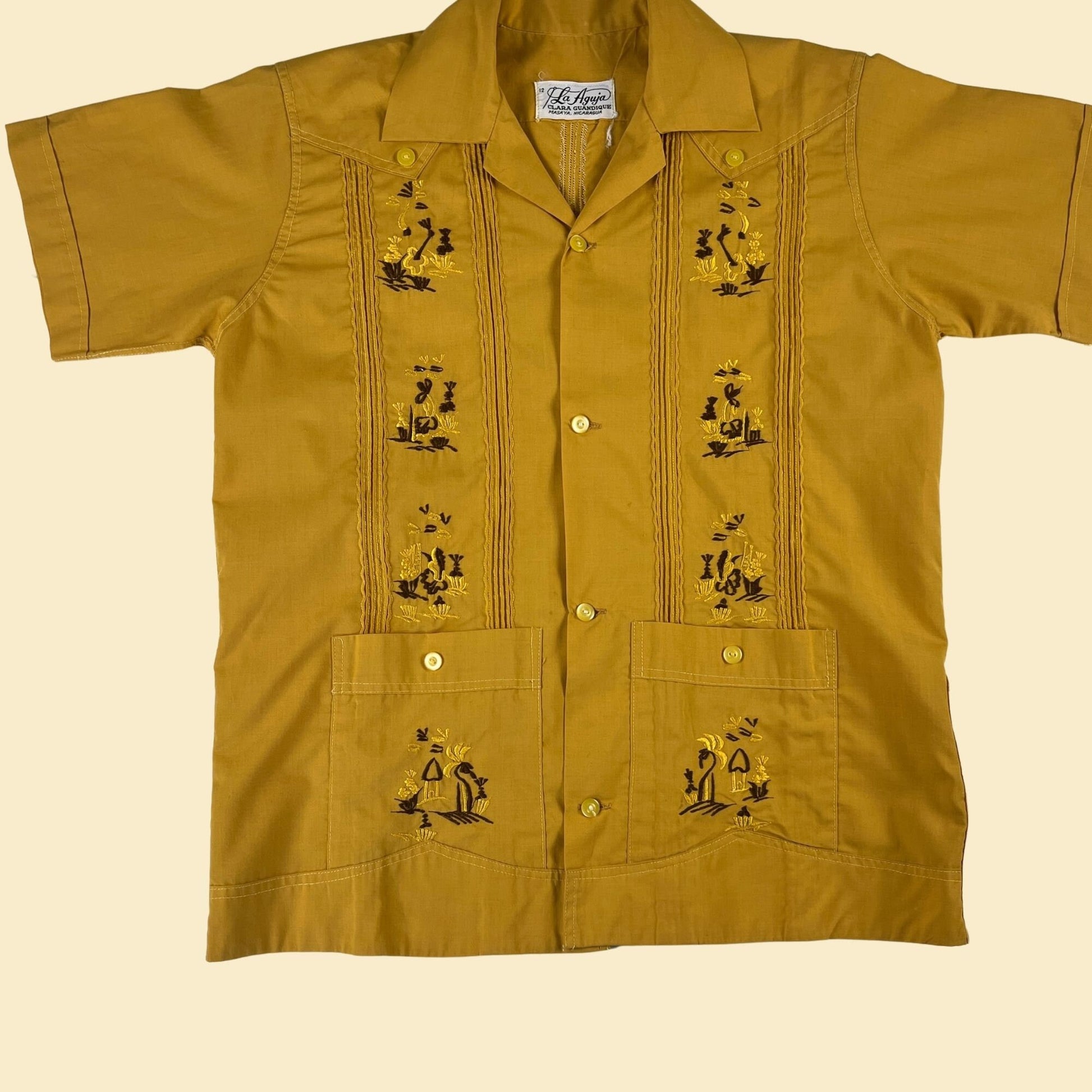 1970s mustard yellow button down, kid's size 12, embroidered tree and hut patterned vintage 70s shirt