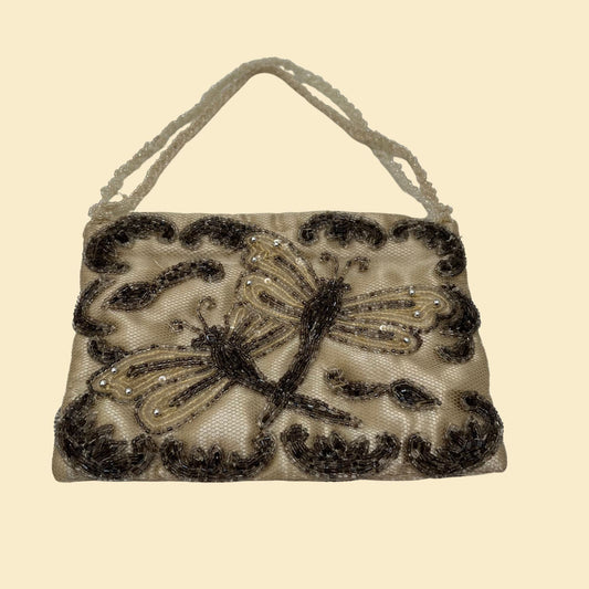 Vintage handbag in beige with dark colored glass beads in a dragonfly design.