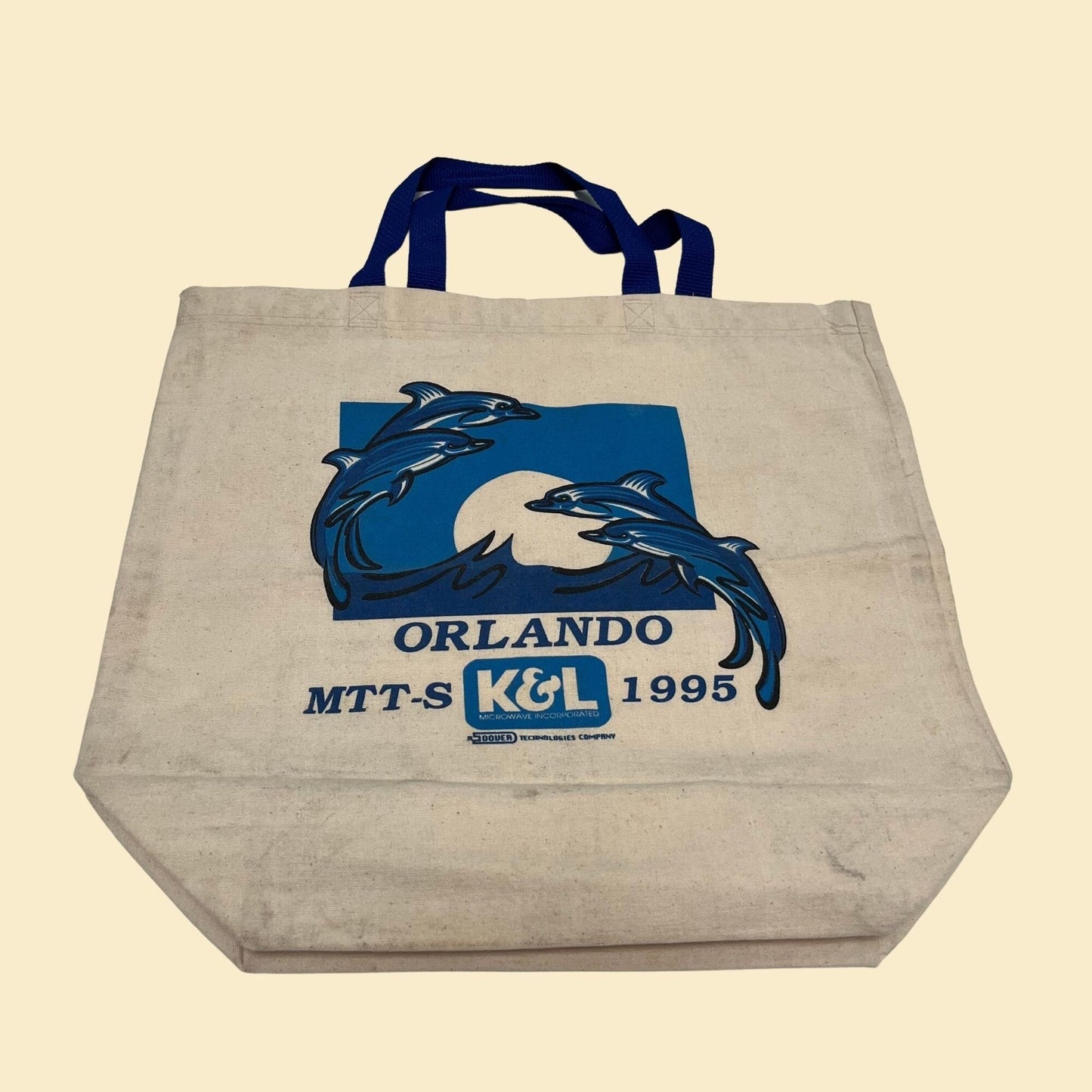 Vintage canvas bag with blue dolphin graphics.