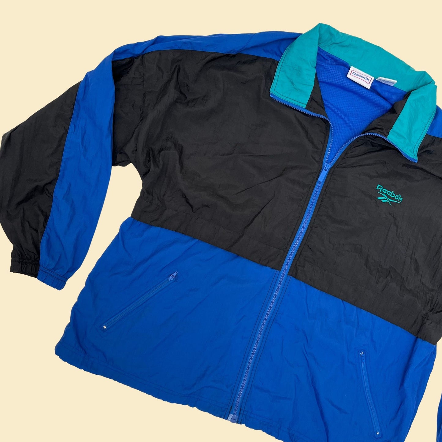 Vintage XL Reebok windbreaker jacket, 1990s color block patterned windbreaker with retractable hood, blue black and teal tracksuit top