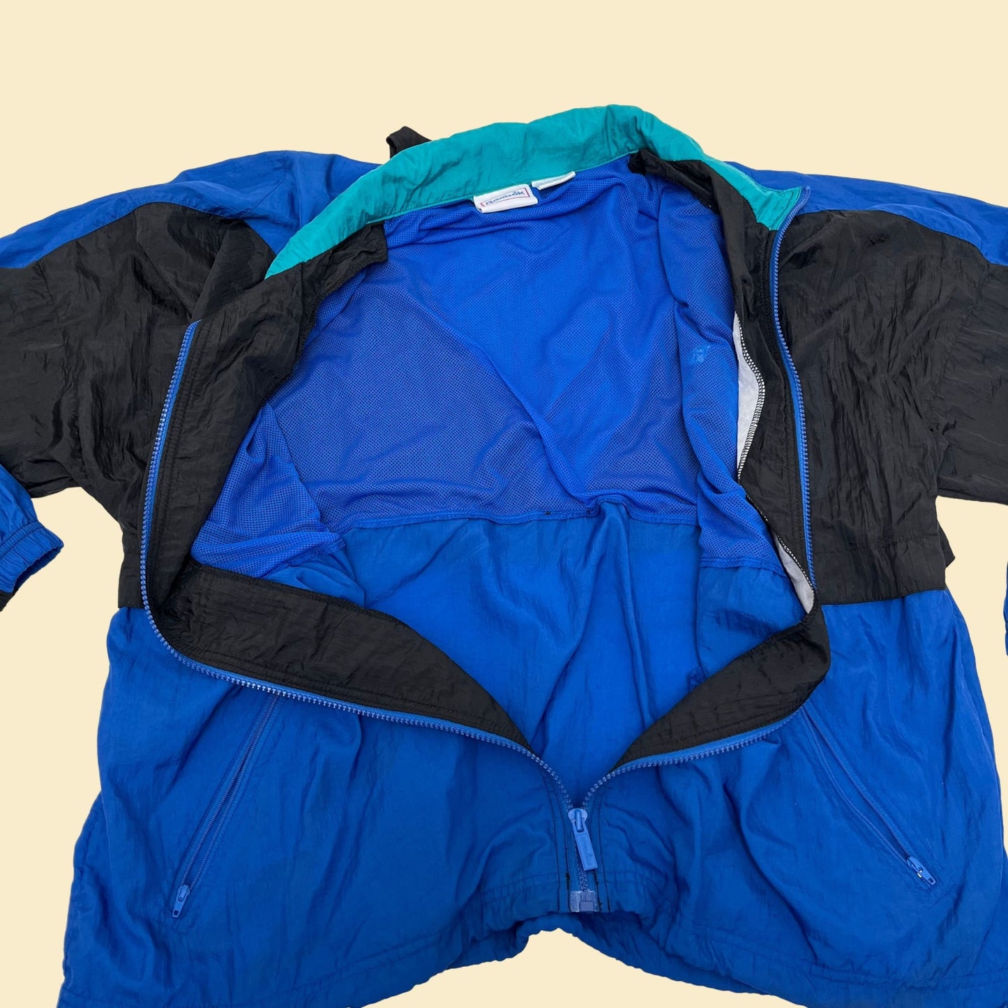 Vintage XL Reebok windbreaker jacket, 1990s color block patterned windbreaker with retractable hood, blue black and teal tracksuit top