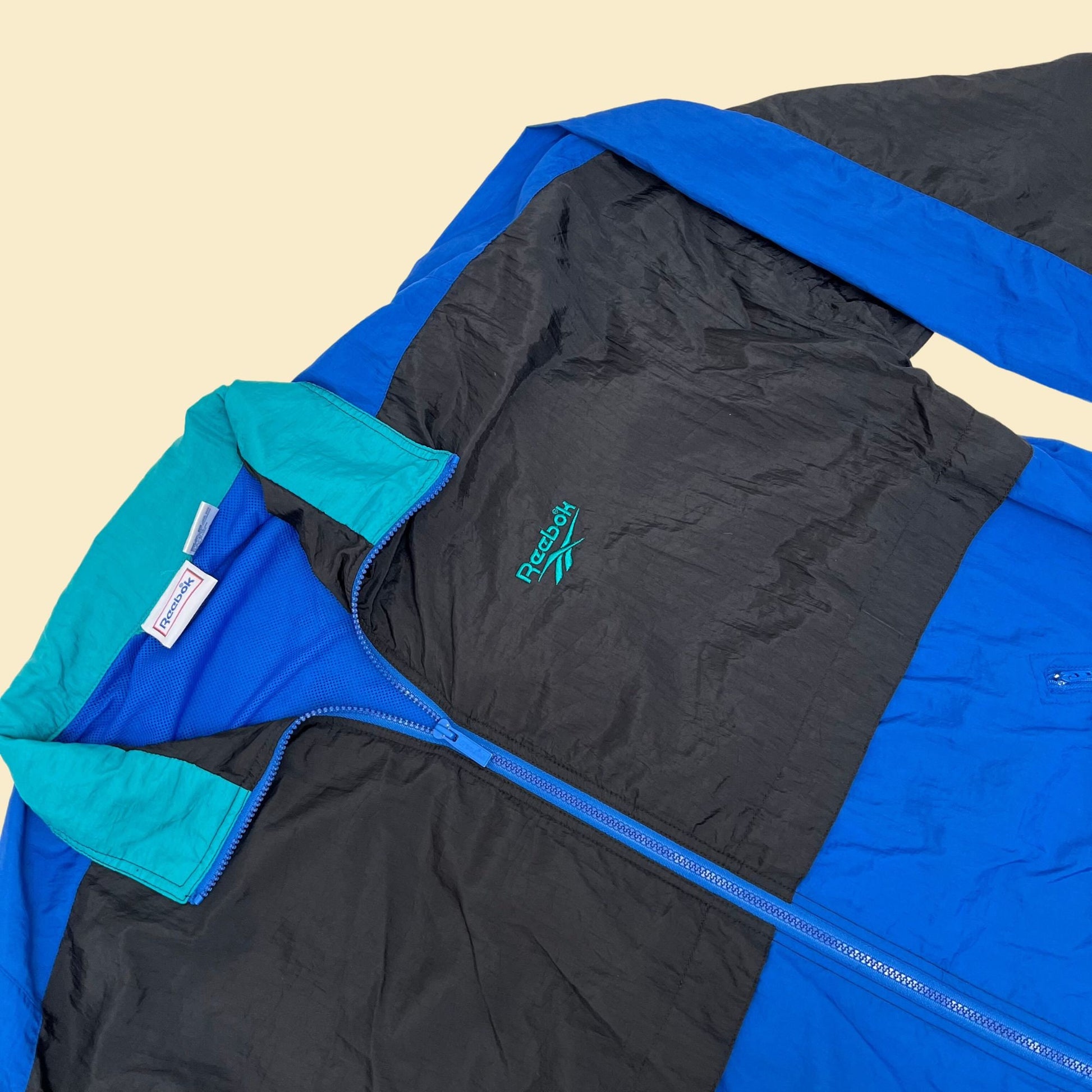 Vintage XL Reebok windbreaker jacket, 1990s color block patterned windbreaker with retractable hood, blue black and teal tracksuit top