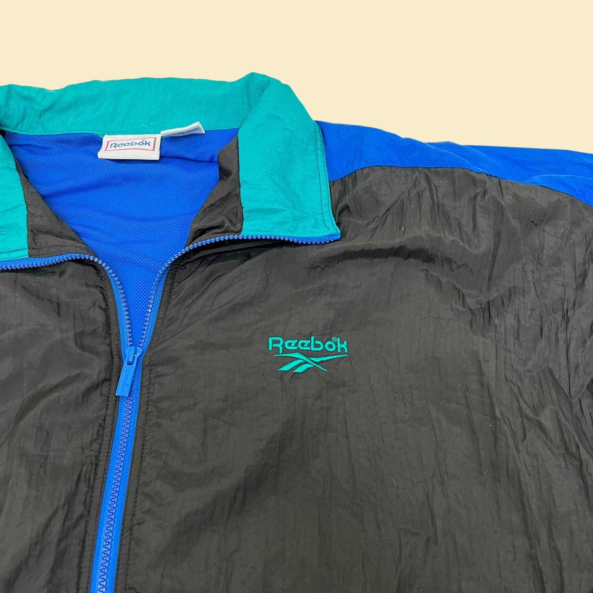 Vintage XL Reebok windbreaker jacket, 1990s color block patterned windbreaker with retractable hood, blue black and teal tracksuit top