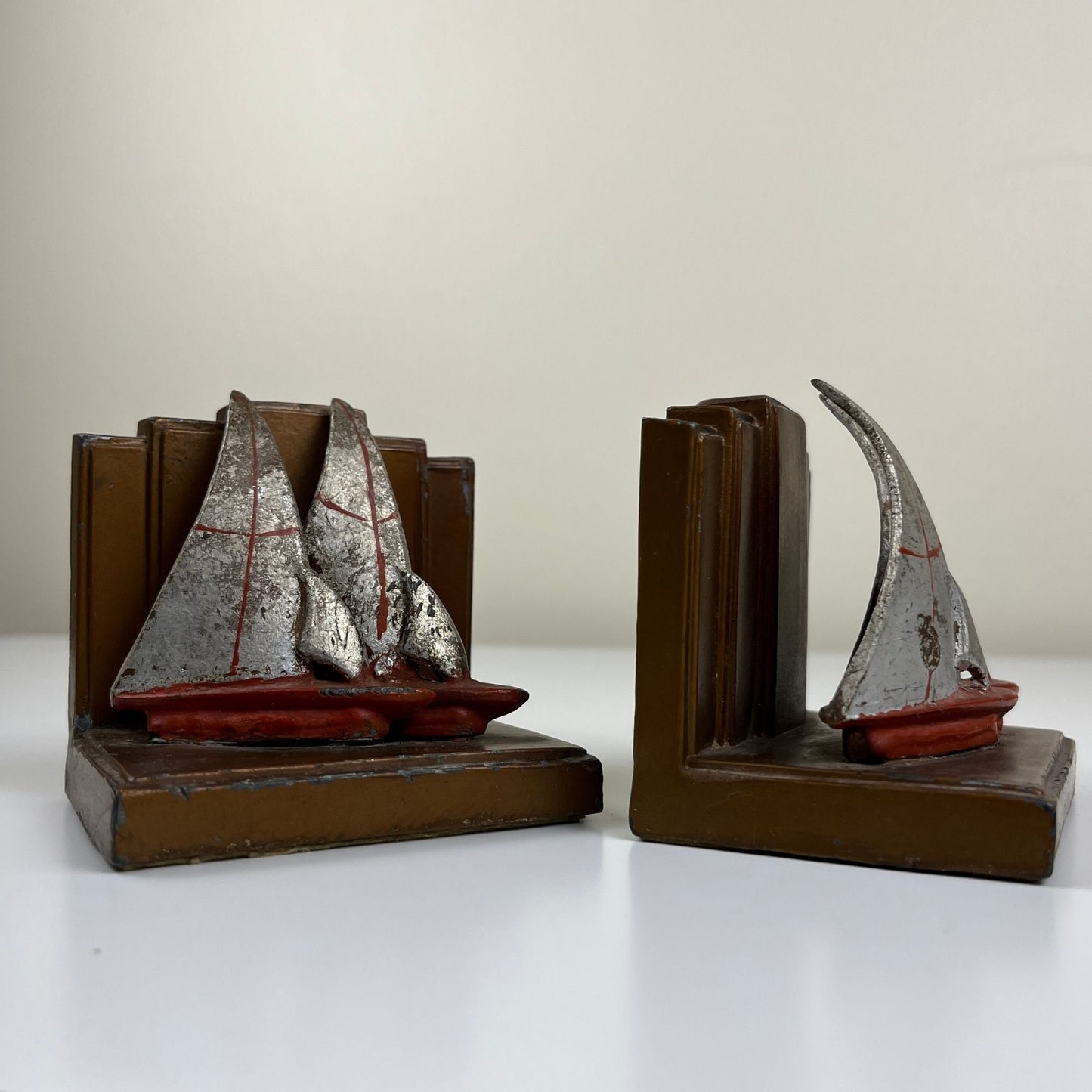 Art deco sailboat bookends, c. 1920s-1930s vintage sailboat heavy book ends, red, grey & copper colored